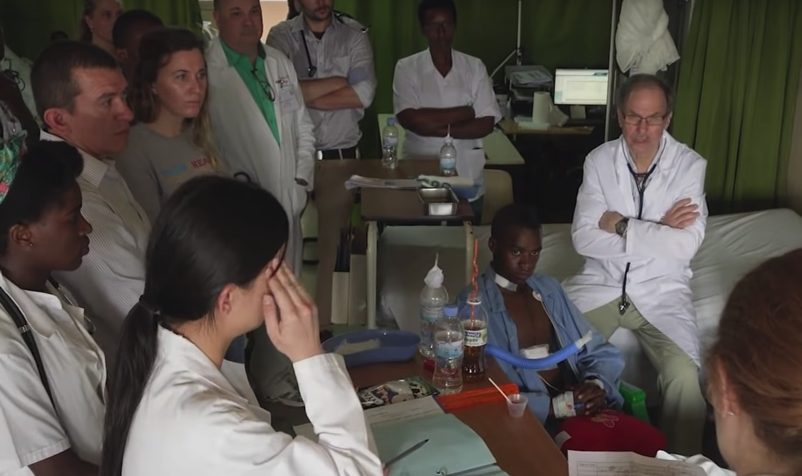 doctors gather around patient